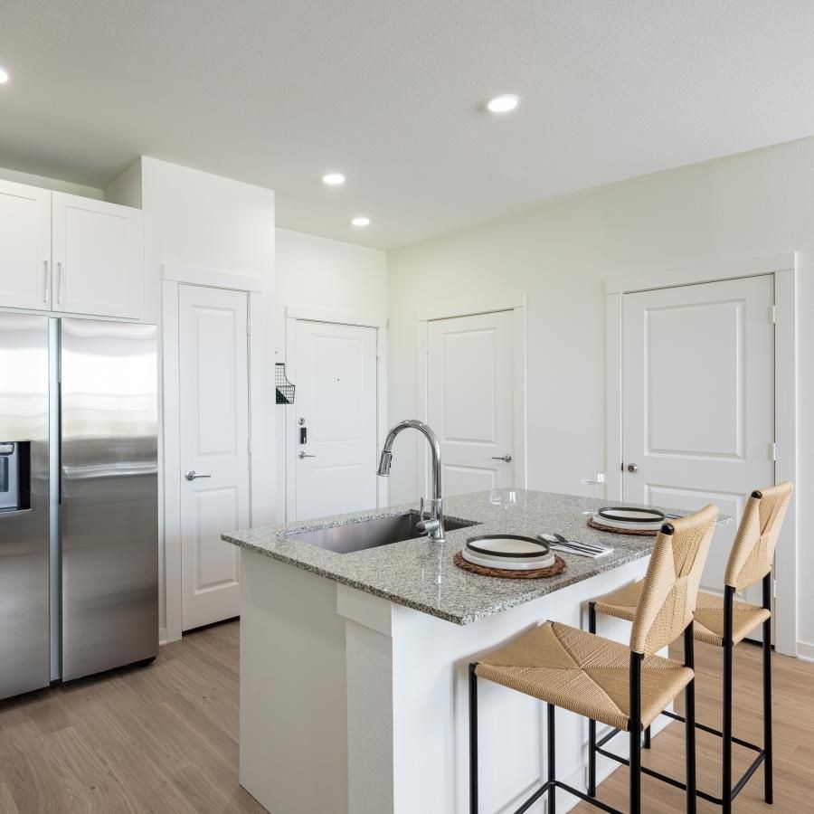 a kitchen with white cabinets