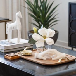 a table with a vase of flowers and a statue of a dog