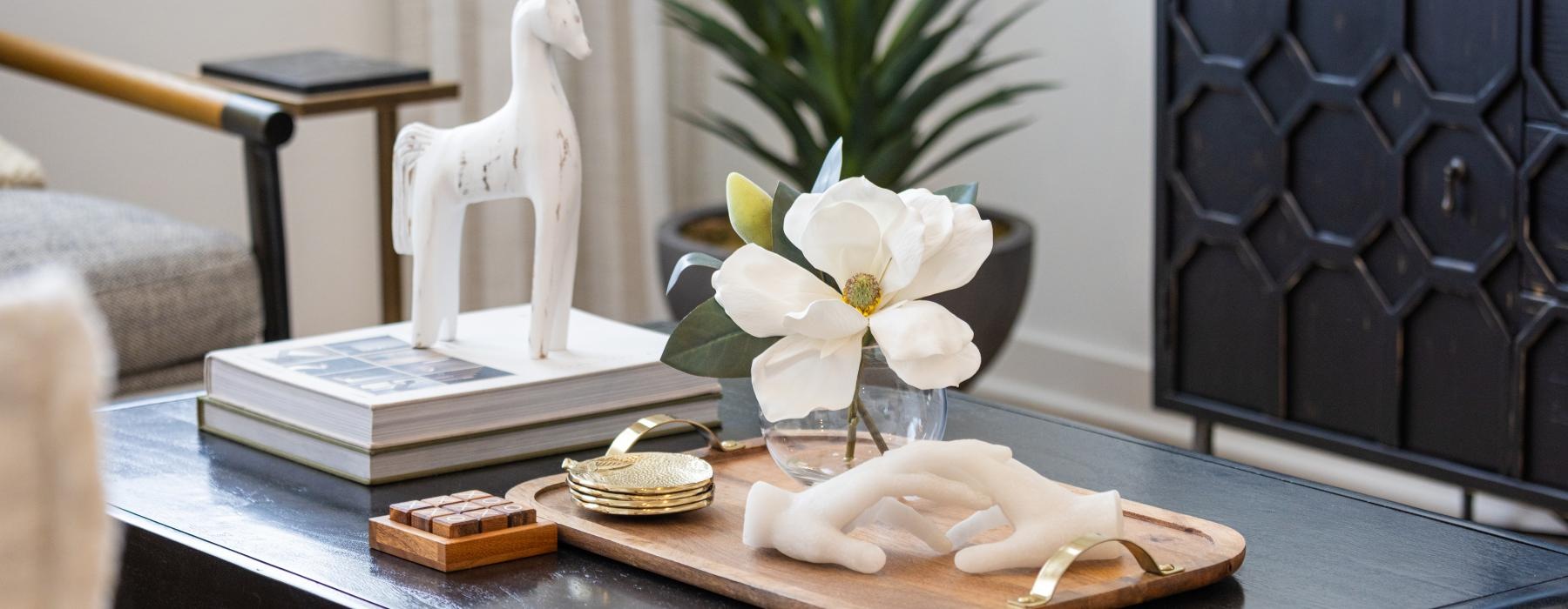 a table with a vase of flowers and a statue of a dog