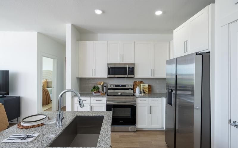a kitchen with white cabinets