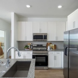 a kitchen with white cabinets